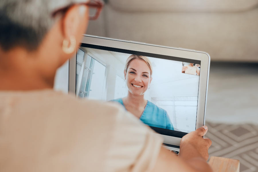 Senior woman using a tablet to consult with a doctor through telehealth